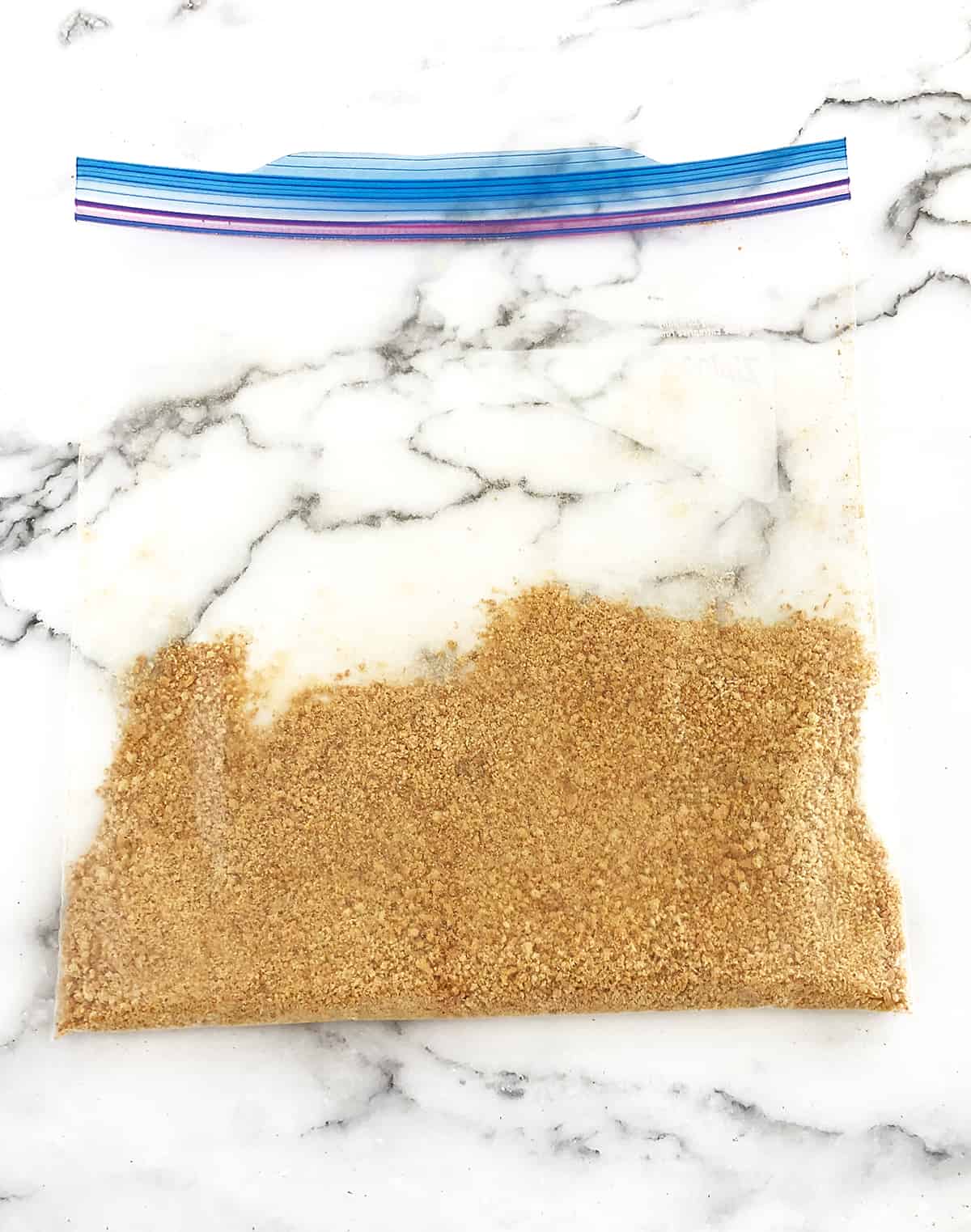 Crush about 3 whole crackers in a Ziploc bag using a pin roller.