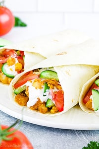 Breakfast tacos are a popular Mexican-American breakfast dish that typically includes scrambled eggs, chorizo, potatoes, and a variety of toppings such as salsa, cucumbers, tomatoes, avocado, sour cream, and bacon or sausage.