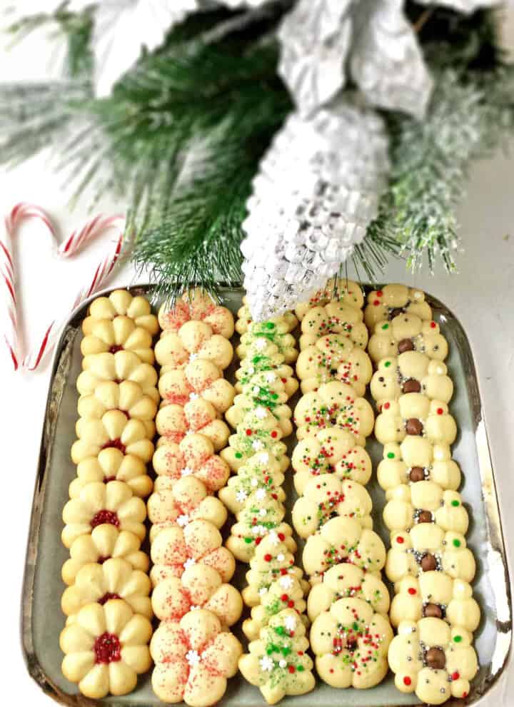 What holiday would dessert plate be complete without these incredible Christmas Spritz Cookies? These may be the most popular, classic Christmas cookies you'll ever make. I have been making these Spritz cookies for years and they've become a traditional Christmas cookie recipe in our family.