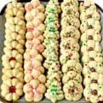 What holiday would dessert plate be complete without these incredible Christmas Spritz Cookies? These may be the most popular, classic Christmas cookies you'll ever make. I have been making these Spritz cookies for years and they've become a traditional Christmas cookie recipe in our family.