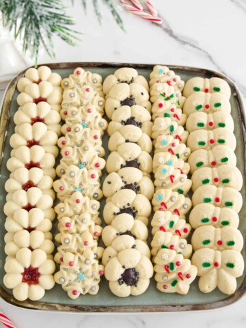 This Christmas Cookies recipe (Spritz Cookies) will give you classic and delicious flavors easily at home! With festive shapes and decor these are bound to win everyone's heart!