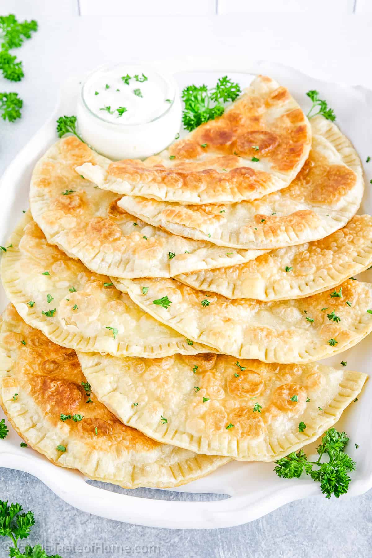 These delicious, savory cheburеki are best served hot, with a side of sour cream. Enjoy the authentic flavors and comforting warmth of this traditional dish.