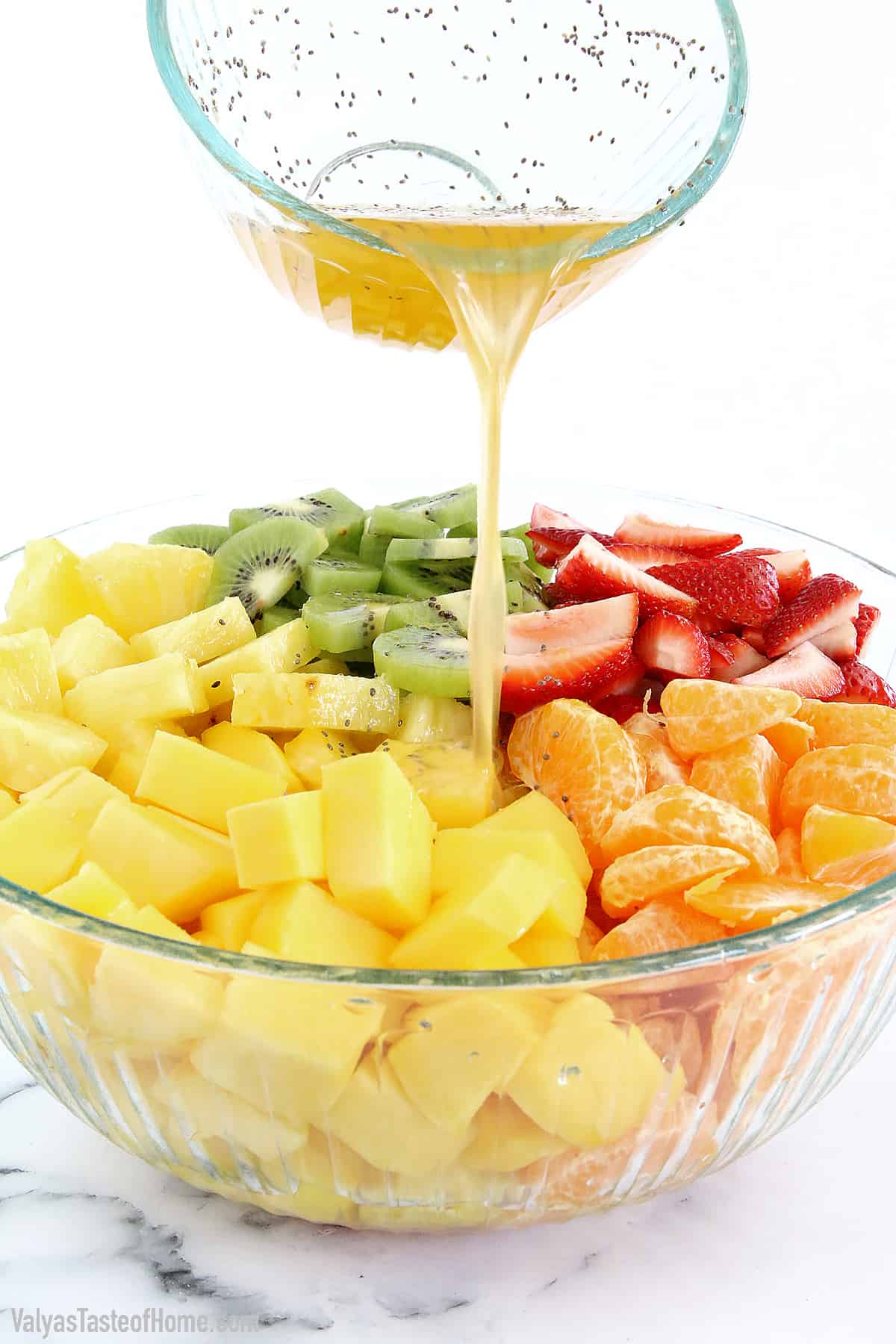Pour the dressing over the fruit salad.
