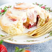 These Strawberry Cinnamon Rolls feature delicious cinnamon rolls with a twist! They're filled with a delicious strawberry jam and fresh strawberries then rolled to perfection and topped off with a tasty homemade frosting.
