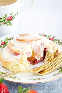 These Strawberry Cinnamon Rolls feature delicious cinnamon rolls with a twist! They're filled with a delicious strawberry jam and fresh strawberries then rolled to perfection and topped off with a tasty homemade frosting.