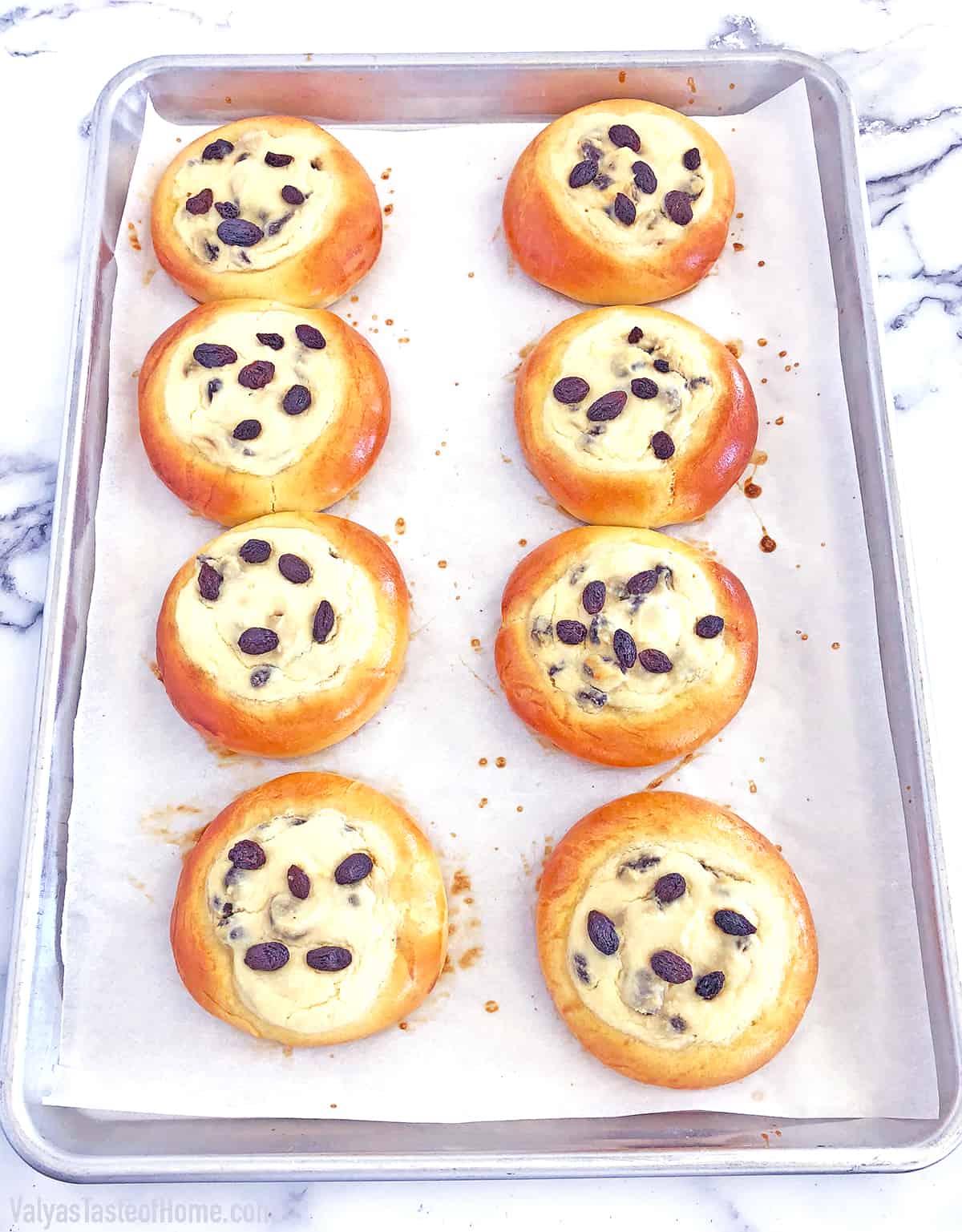 These Sweet Buns with Farmers Cheese and Raisins are made with a slightly sweet yeast dough that is topped with sweet farmer's cheese filling and is very popular in Eastern Europe.