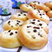 These Sweet Buns with Farmers Cheese and Raisins are made with a slightly sweet yeast dough that is topped with sweet farmer's cheese filling and is very popular in Eastern Europe.