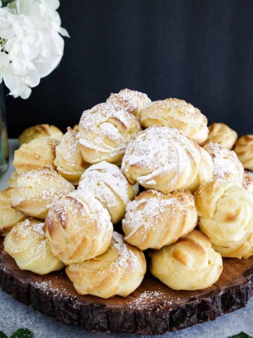 Cream puffs are a classic French dessert that are made by baking choux pastry dough (also known as pâte à choux) in small, round mounds.