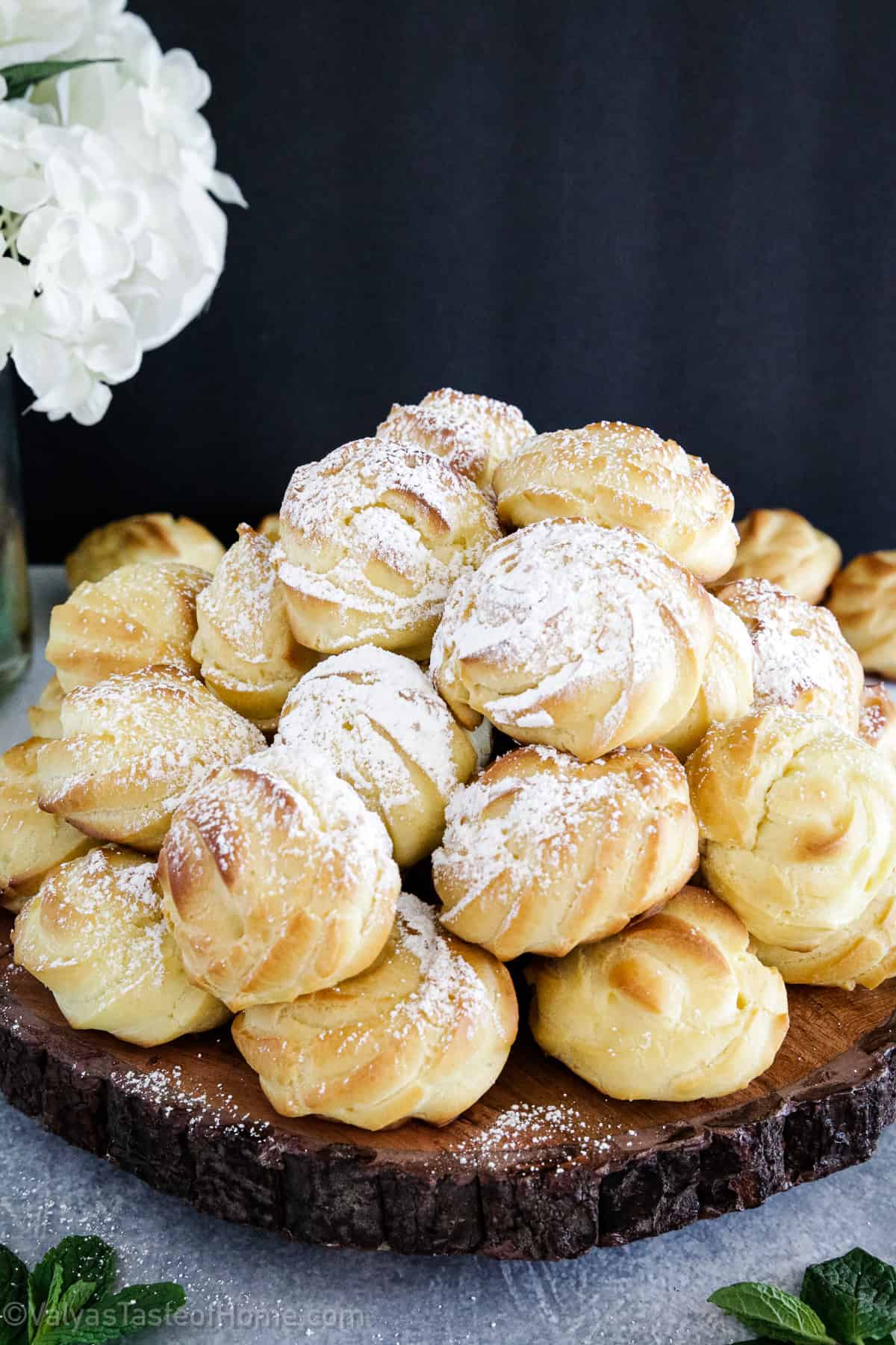 Cream Puffs are a classic French dessert that are filled with a creamy, sweet filling and sprinkled with powdered sugar for a delicious treat!