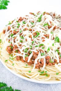 The dish is then finished off with a generous amount of melted cheese, such as parmesan cheese or mozzarella.