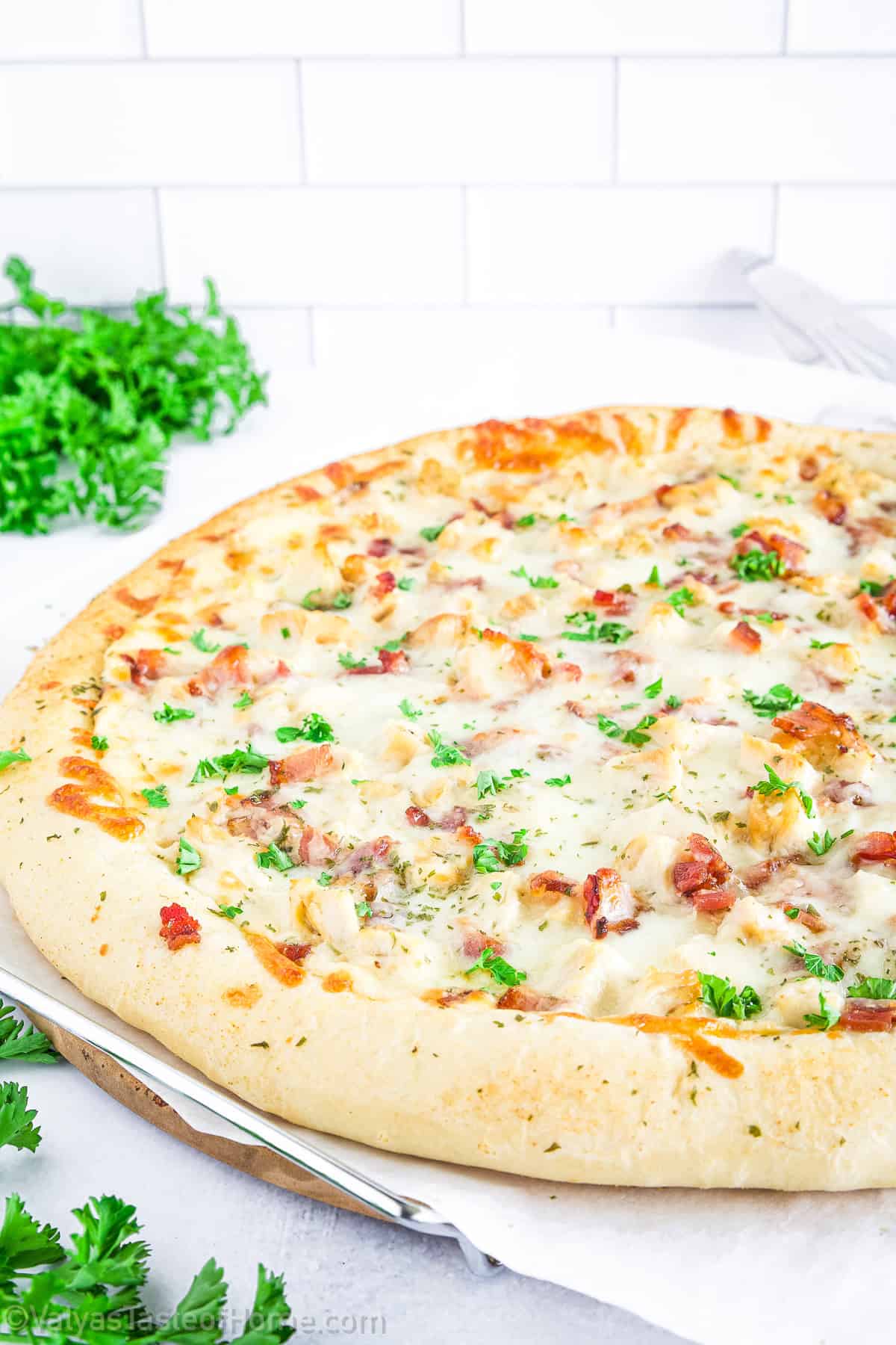 This Chicken Bacon Alfredo Pizza is a fresh oven-baked pizza loaded with extra Romano cheese, pressed garlic in Alfredo sauce, and a crispy thin crust that’s irresistible.