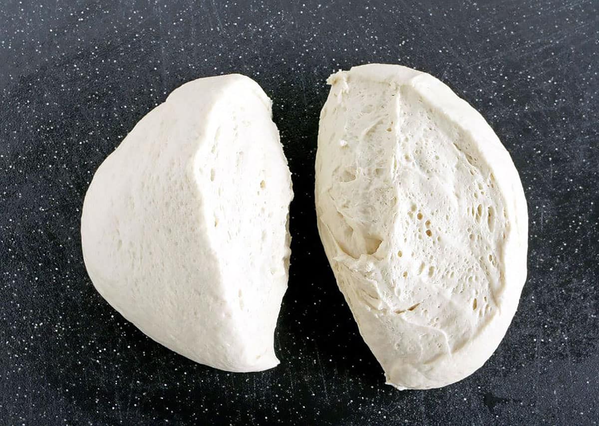 We start with 2 halves of pizza dough, which provide a sturdy and delicious base for our pizza.