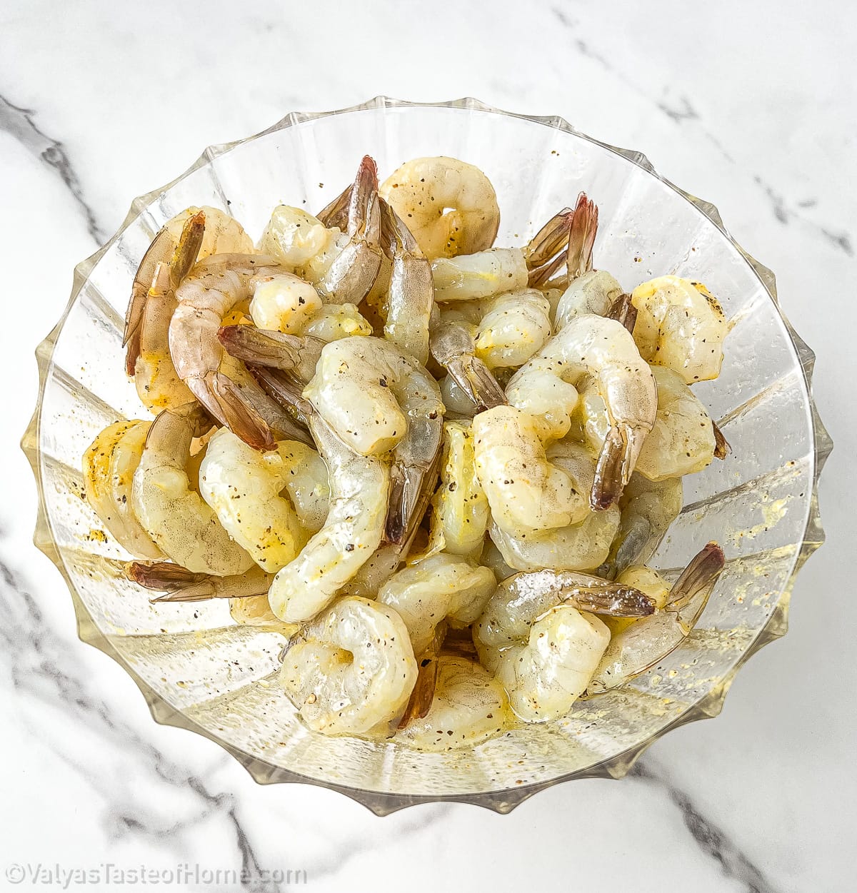 Use your hands or a spoon to mix the seasonings into the shrimp, and make sure that they are evenly coated.