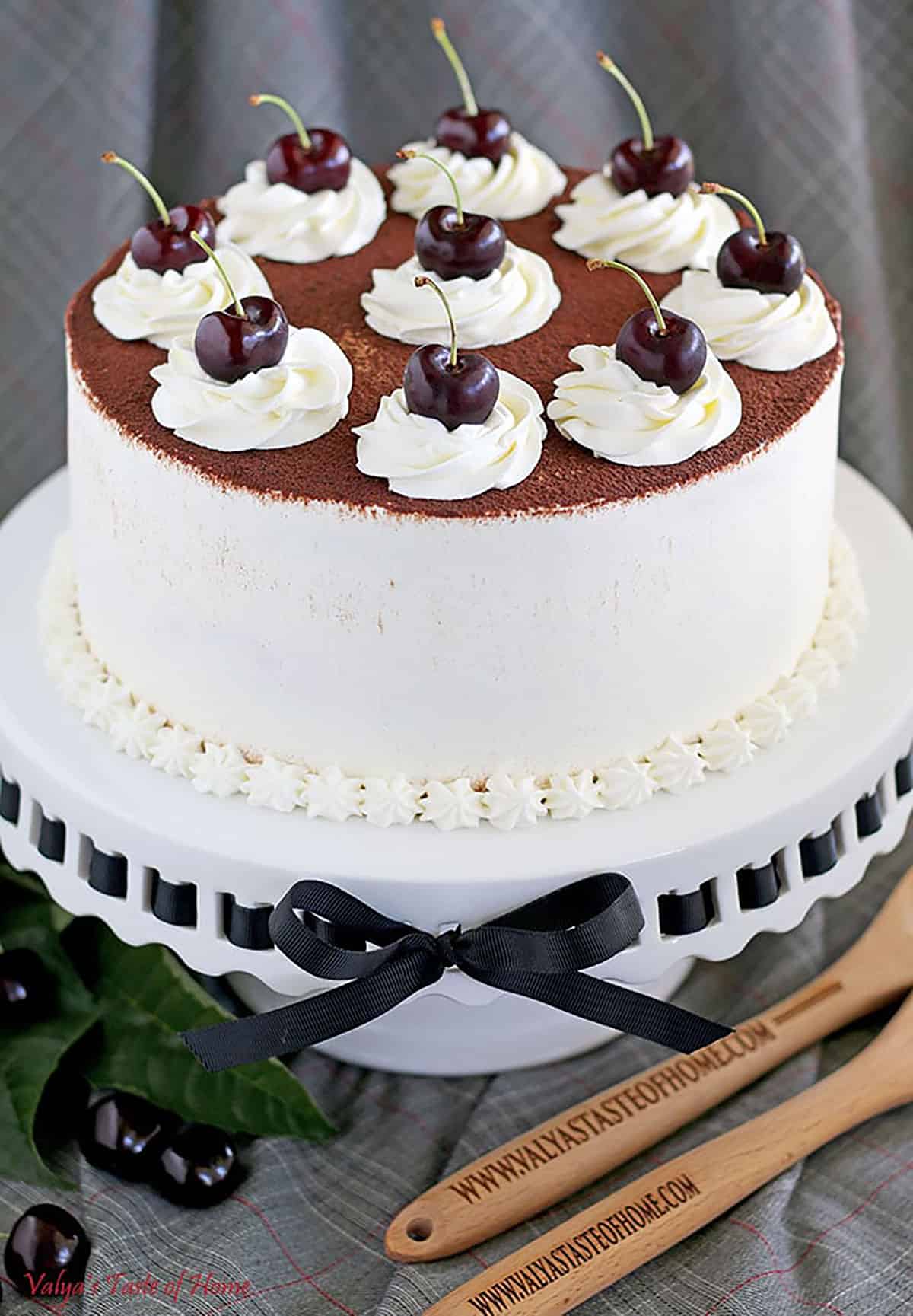 This Black Cherry Cake has a moist chocolate cake sponge, soaked with black cherry syrup, and is layered with light cream and cocoa powder on top. Incredibly delicious!