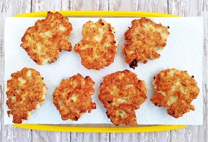 Once done, place sautéed fritters onto a plate or cutting board lined with paper towels to soak in excess oil