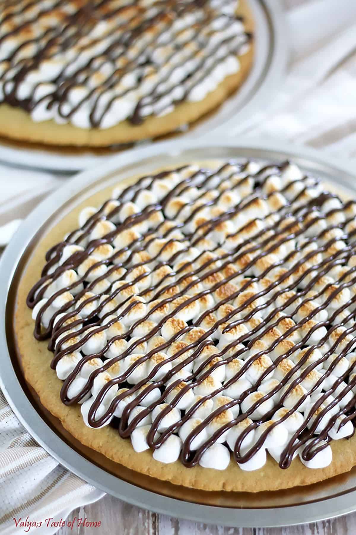 It features a homemade sugar cookie crust, with toasted mini marshmallows and melted chocolate chips to satisfy your sweet tooth.