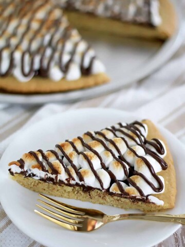 This S'mores Dessert Pizza crust is made out of the Easy Homemade Sugar Cookie Dough Recipe. The baked pizza tastes just like your typical S'mores. And it’s super easy to make!