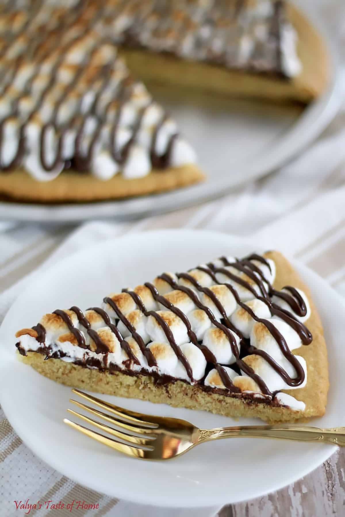 This S'mores Dessert Pizza crust is made out of the Easy Homemade Sugar Cookie Dough Recipe. The baked pizza tastes just like your typical S'mores. And it’s super easy to make!