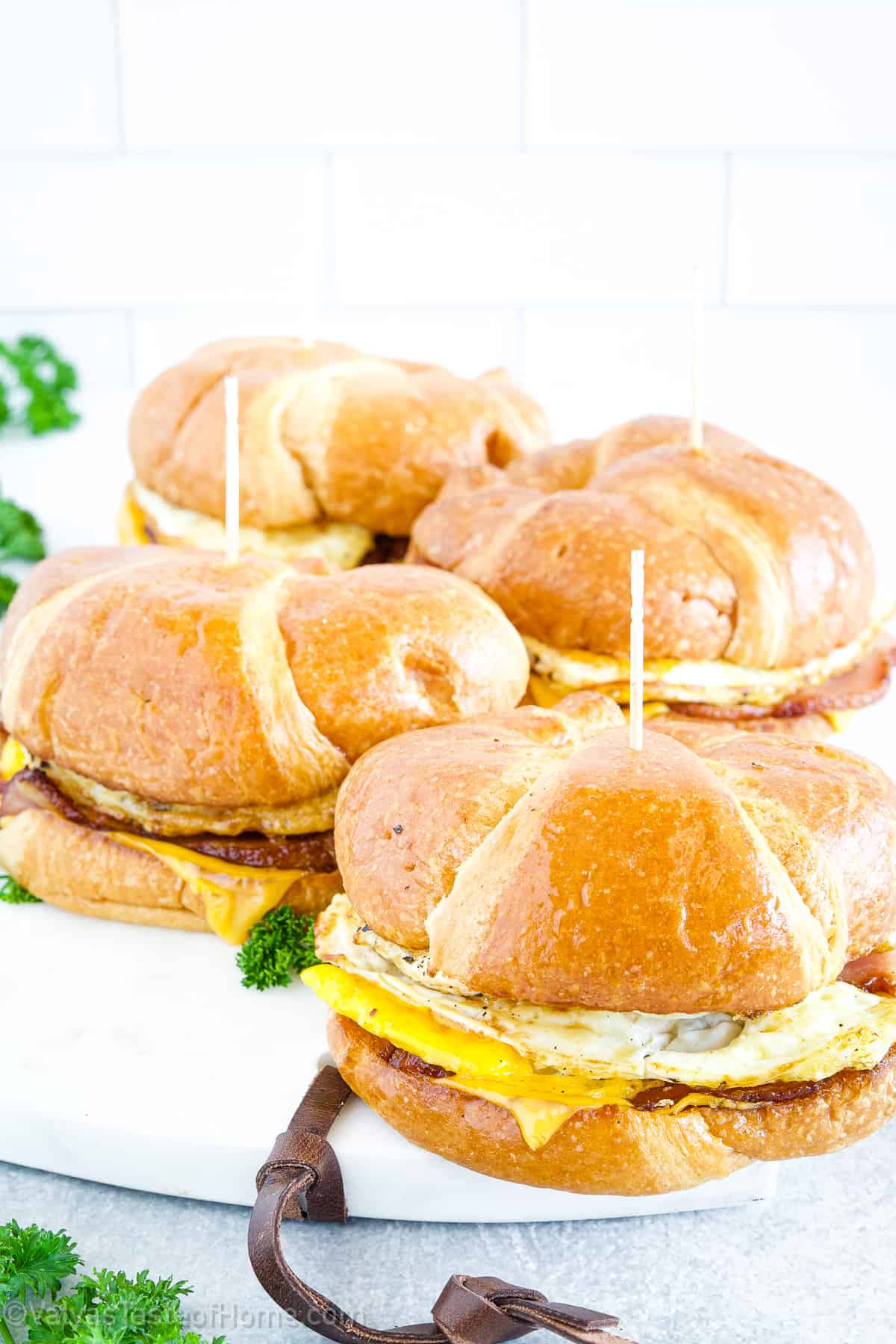 The buttery and flaky croissant pairs perfectly with savory eggs and cheese, while the addition of bacon or sausage adds a delicious smoky and salty element.