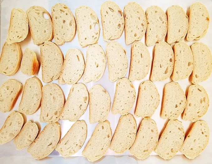 Lay the bread slices flat on a baking sheet and let it sit out in the pantry overnight.