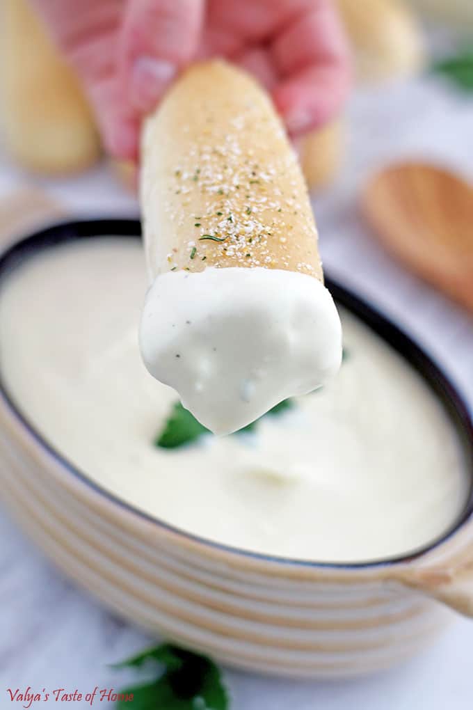 Dip homemade breadsticks into this delicious warm sauce made at home!