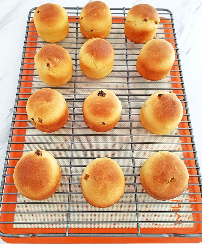 Place them on a wire rack for glazing. Be ready to begin glazing as soon as the mini-Paskas have cooled down to warm.