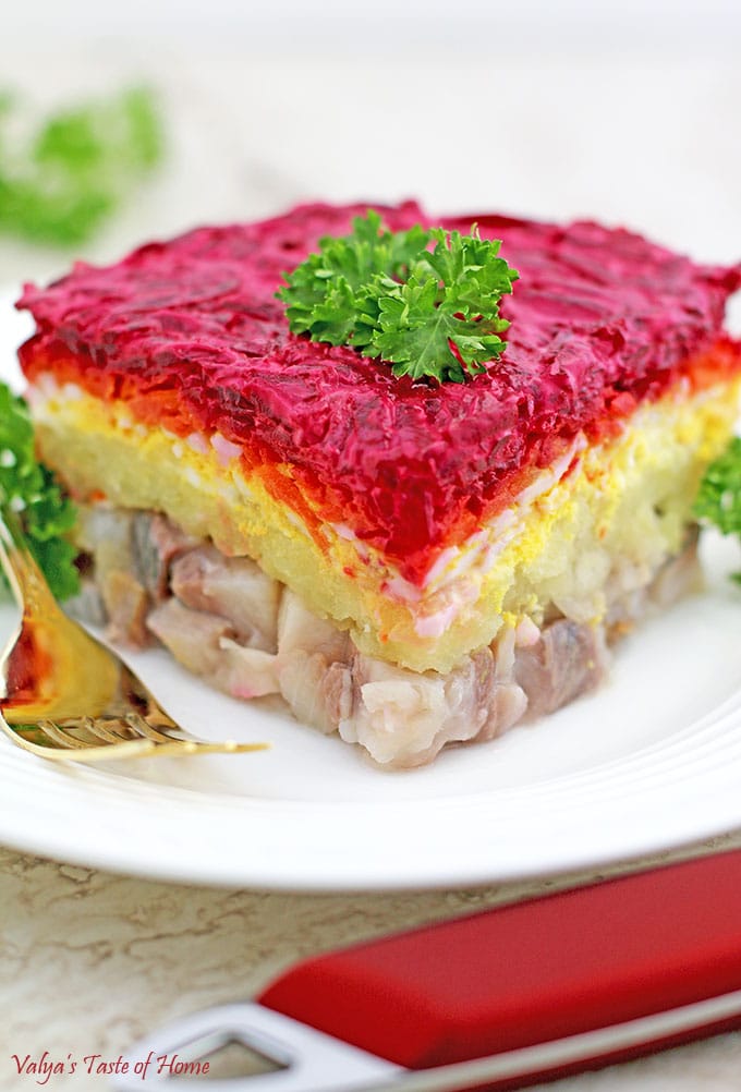 Shuba salad consists of layered herring, grated potatoes, eggs, carrots, and red beets and is coated with mayonnaise and seasoned with salt and pepper to taste. 