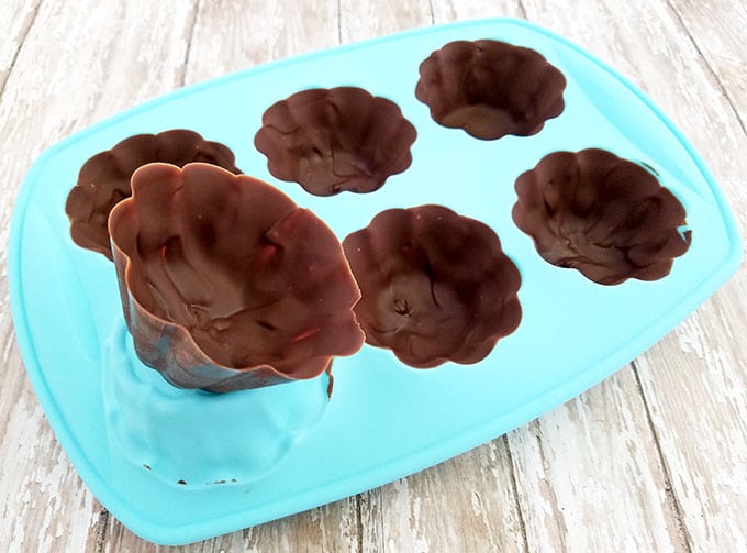 Remove the mold from the freezer and remove chocolate cups from the molds one by one, careful not to break them.