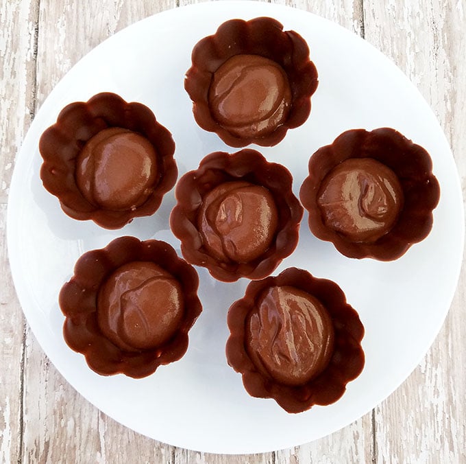 Fill the chocolate cups by adding ¼ cup of chocolate pudding to the bottom of each chocolate cup.