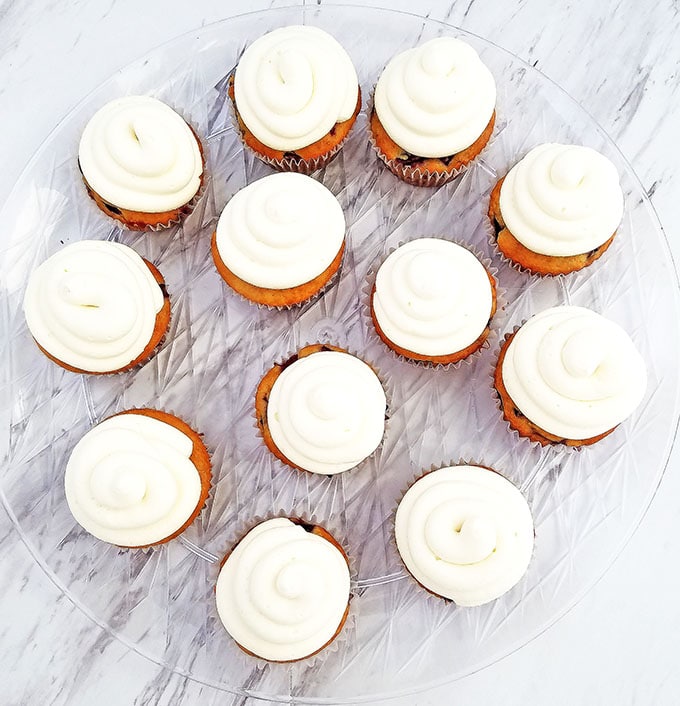 Pipe each cupcake top with cream in an outside-in spiral design.