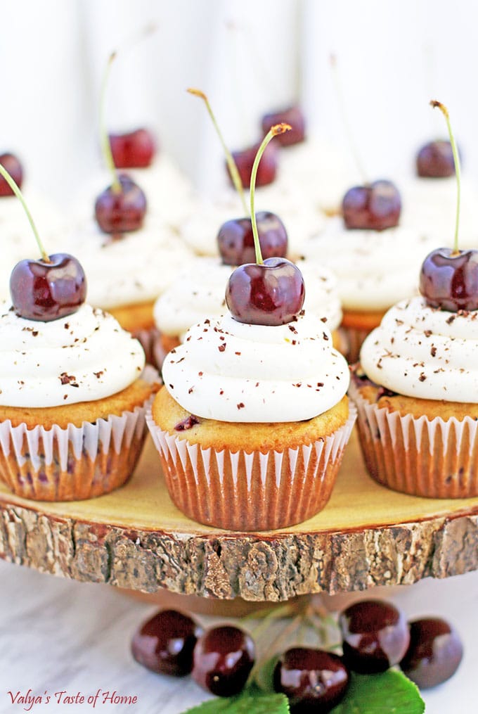 Garnish each cupcake with a cherry and sprinkle grated chocolate.