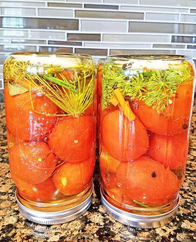 After taking the jars out of the water, tighten the lids securely, then turn them upside down and let them cool completely on your countertop for about 12 hours.