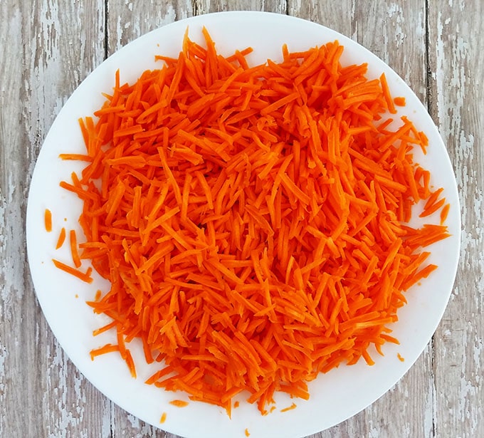 Peel, rinse, and grate carrots, and then set them aside until ready to use.