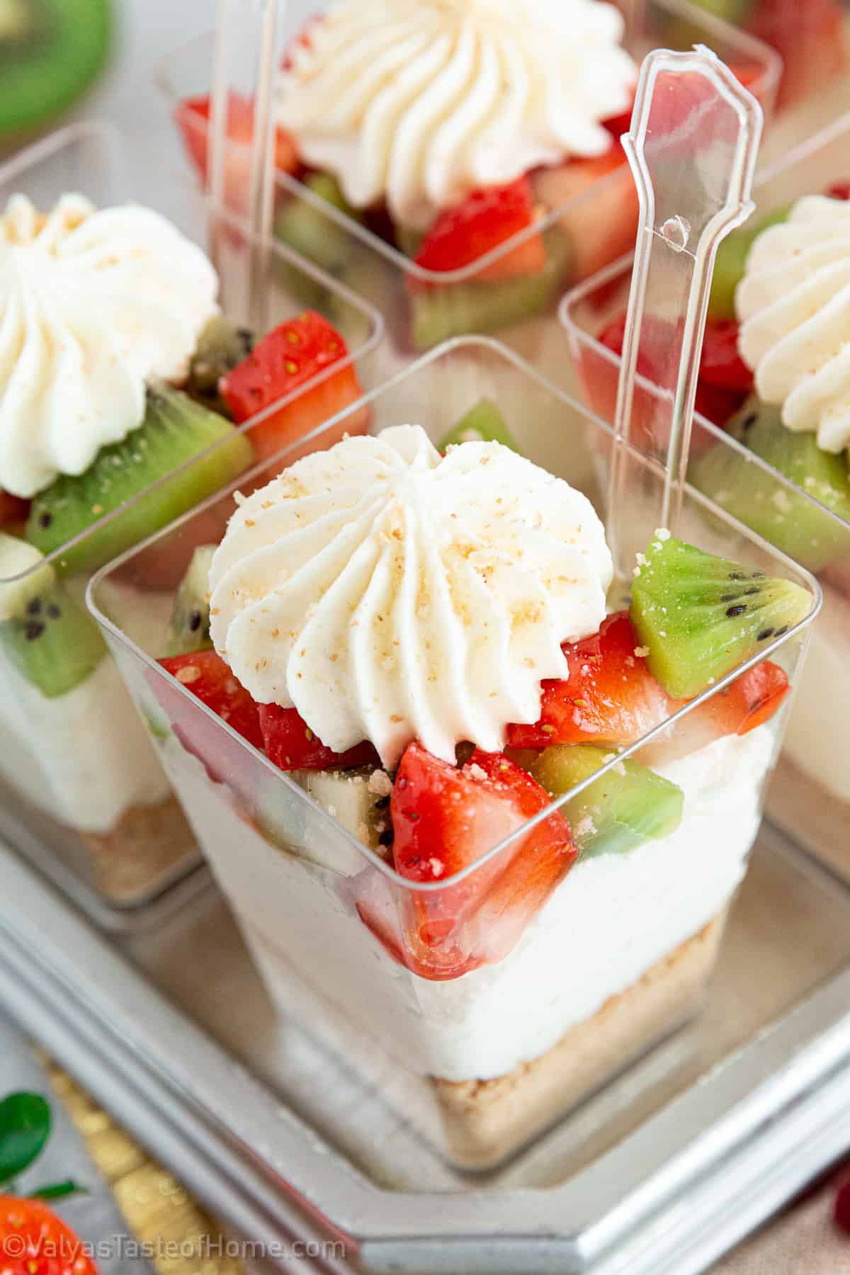 And this particular recipe is for Strawberry Kiwi Cheesecake Parfaits that have a delicious graham cracker crust layer, topped with a cheesecake filling, and topped with strawberries and kiwis.