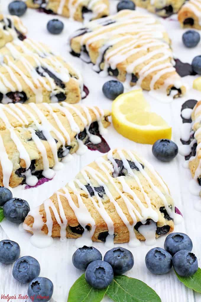 These Lemon Blueberry Scones with Lemon Glaze are light, moist, and fluffy. They have just the right amount of sweetness, drizzled with lemony goodness, which makes them taste simply scrumptious! Scones make a perfect breakfast, brunch, or an afternoon coffee break.