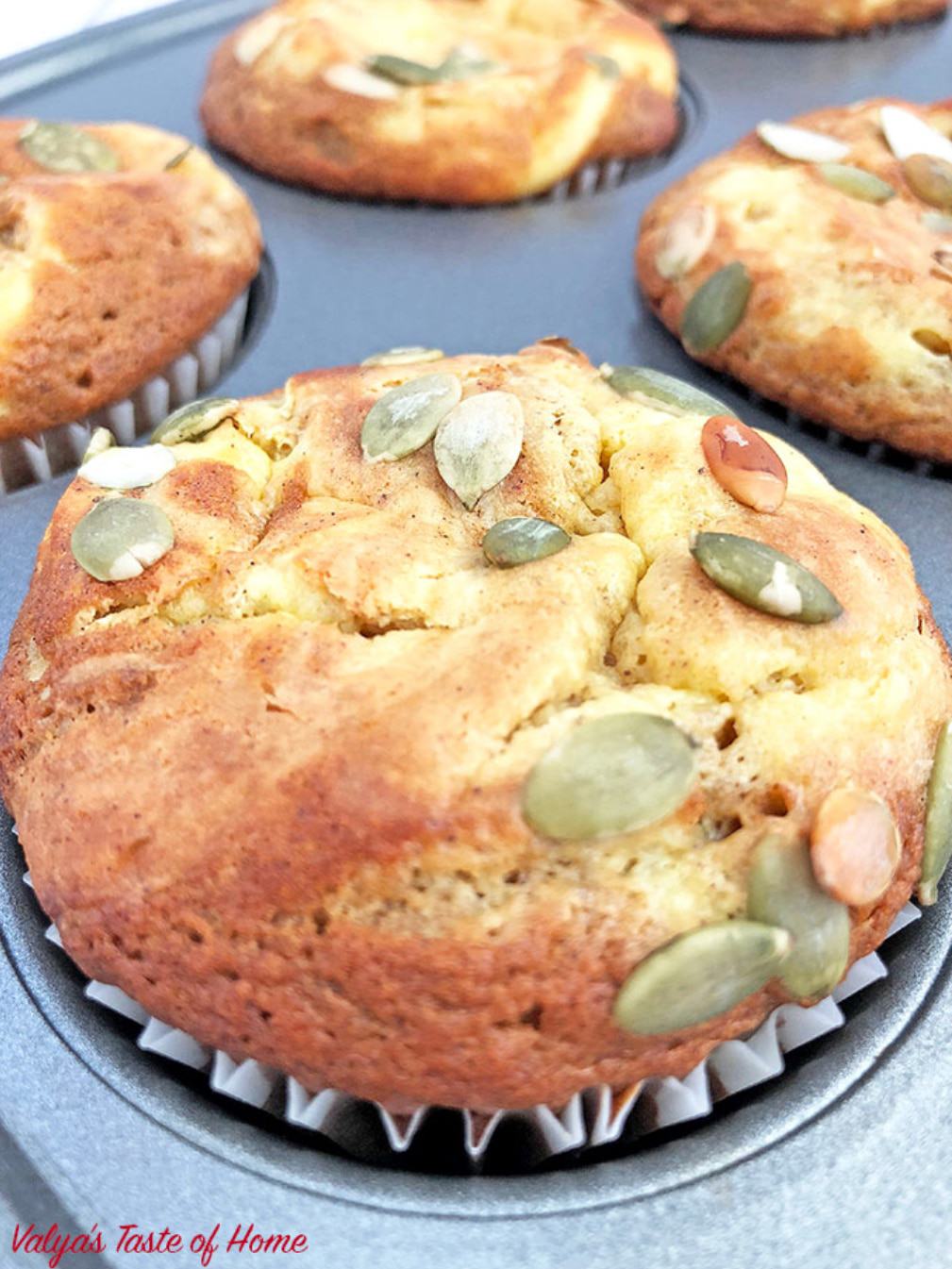These Pumpkin Cheesecake Muffins are a must-bake fall treat! They are super moist, pillowy soft, fluffy, swirled with cheesecake batter, topped with pumpkin seeds and a burst of the fall flavor. #pumpkincheesecakemuffins #homemade #softandmoist #cheesecakemuffins #valyastasteofhome