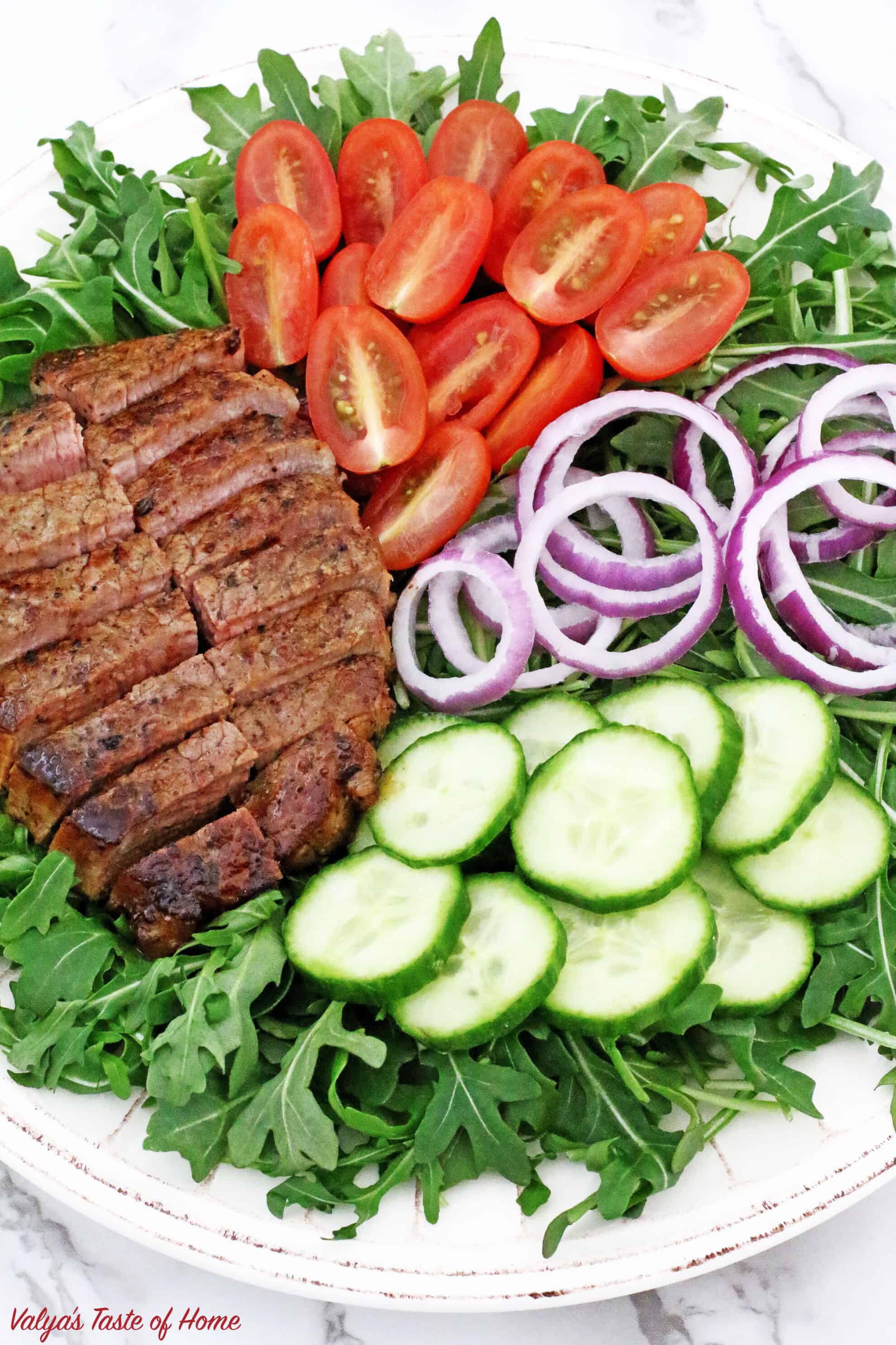 This Arugula Steak Salad with Balsamic Vinaigrette Dressing is very colorful, light, crunchy, flavorful, refreshing and satisfying, it is sure to impress! If your New Year’s resolution is to eat healthily or whether you want to detox your body I would recommend adding this superfood - ARUGULA to your diet. While most green vegetables are considered healthy and nutritious, arugula does stand out among the rest of the greens do to very low in calorie but high in calcium, iron and other nutrients.
