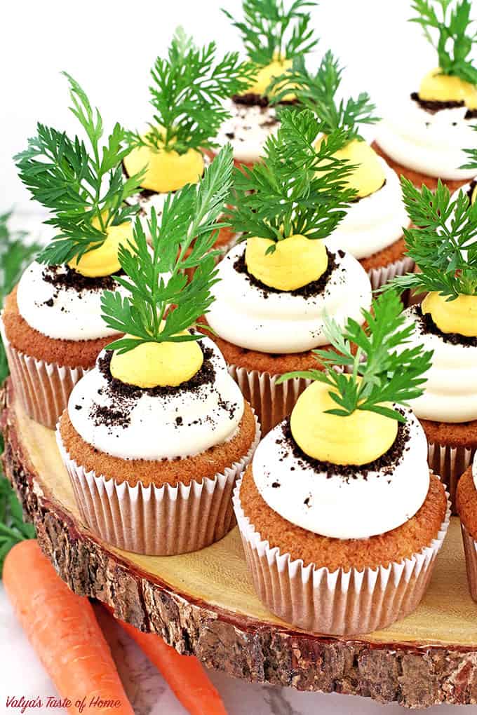 These Carrot Cupcakes with Greek Yogurt Cream Cheese Frosting are amazingly soft, light, moist, and packed with organic freshly grated carrots. Each cupcake is beautifully decorated to represent the growing carrot in the dirt.  The cream is very tasty and not sweet at all. The addition of Greek yogurt makes it taste soft and creamy, you will be licking your fingers off with every bite!