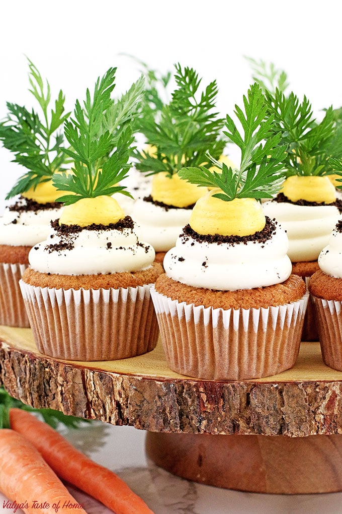 These Carrot Cupcakes with Greek Yogurt Cream Cheese Frosting are amazingly soft, light, moist, and packed with organic freshly grated carrots. Each cupcake is beautifully decorated to represent the growing carrot in the dirt.  The cream is very tasty and not sweet at all. The addition of Greek yogurt makes it taste soft and creamy, you will be licking your fingers off with every bite!