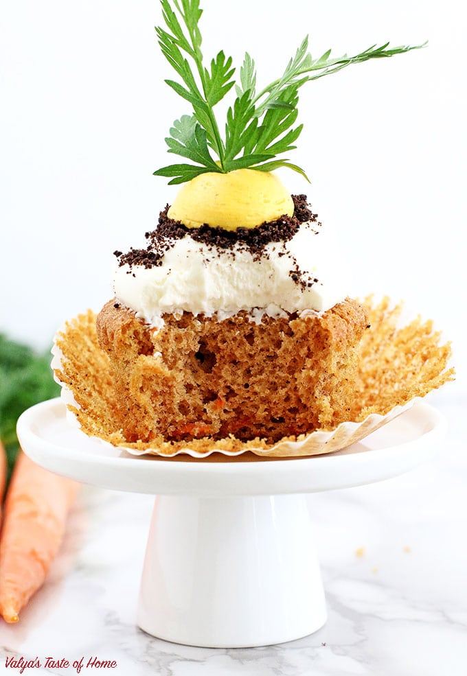 These Carrot Cupcakes with Greek Yogurt Cream Cheese Frosting are amazingly soft, light, moist, and packed with organic freshly grated carrots. Each cupcake is beautifully decorated to represent the growing carrot in the dirt.  The cream is very tasty and not sweet at all. The addition of Greek yogurt makes it taste soft and creamy, you will be licking your fingers off with every bite!