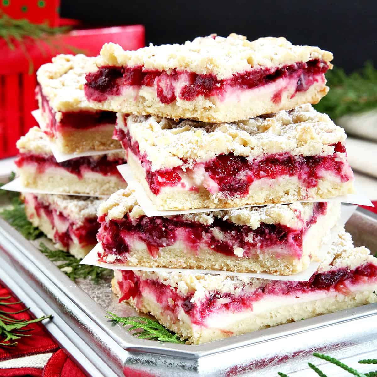 These Cranberry Bars are perfect for the holidays, featuring a tart cranberry filling, soft and crumbly shortbread layer and cream cheese filling to balance it.