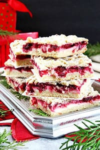 These Cranberry Bars are perfect for the holidays, featuring a tart cranberry filling, soft and crumbly shortbread layer and cream cheese filling to balance it.