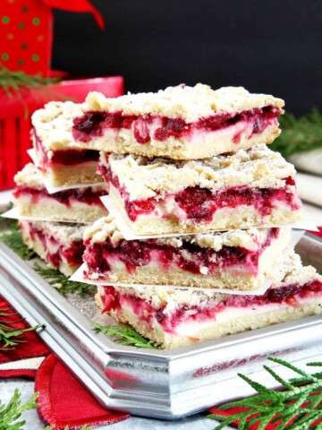 These Cranberry Bars are perfect for the holidays, featuring a tart cranberry filling, soft and crumbly shortbread layer and cream cheese filling to balance it.