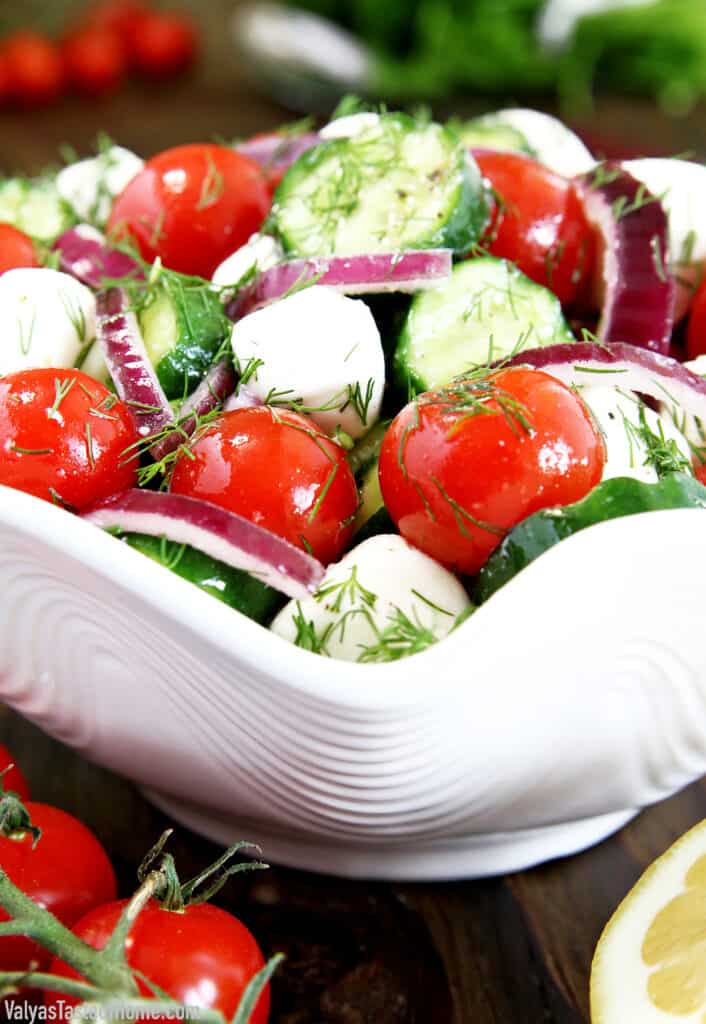 Eating this Tomato Cucumber and Mozzarella Salad makes me think of that kid in the candy store. When mealtime ends, you find yourself picking up the fork again and jabbing the individual ingredients in the salad. Just because they're cute! 