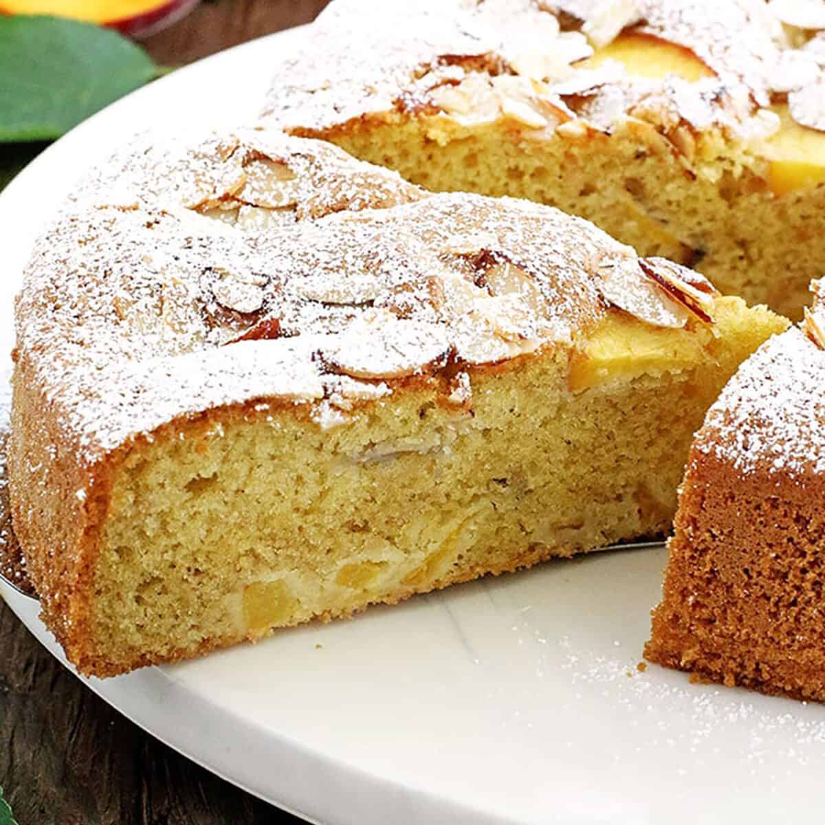 Fluffy cake with a moist crumb, loaded with peaches and topped with almonds, it's the most perfect coffee cake ever!
