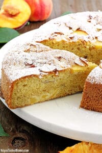 Fluffy cake with a moist crumb, loaded with peaches and topped with almonds, it's the most perfect coffee cake ever!