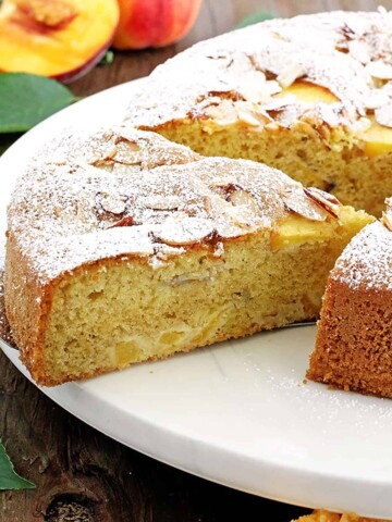Fluffy cake with a moist crumb, loaded with peaches and topped with almonds, it's the most perfect coffee cake ever!