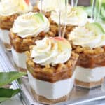 These No-Bake Caramel Apple Pie Cheesecake Parfaits are out of this world delicious! Layers of goodness: crushed buttery graham cracker crust, smooth and creamy cheesecake filling, tasty and rich organic caramel, slathered with fantastic homemade diced apple pie filling, and finally topped with whipped cream.