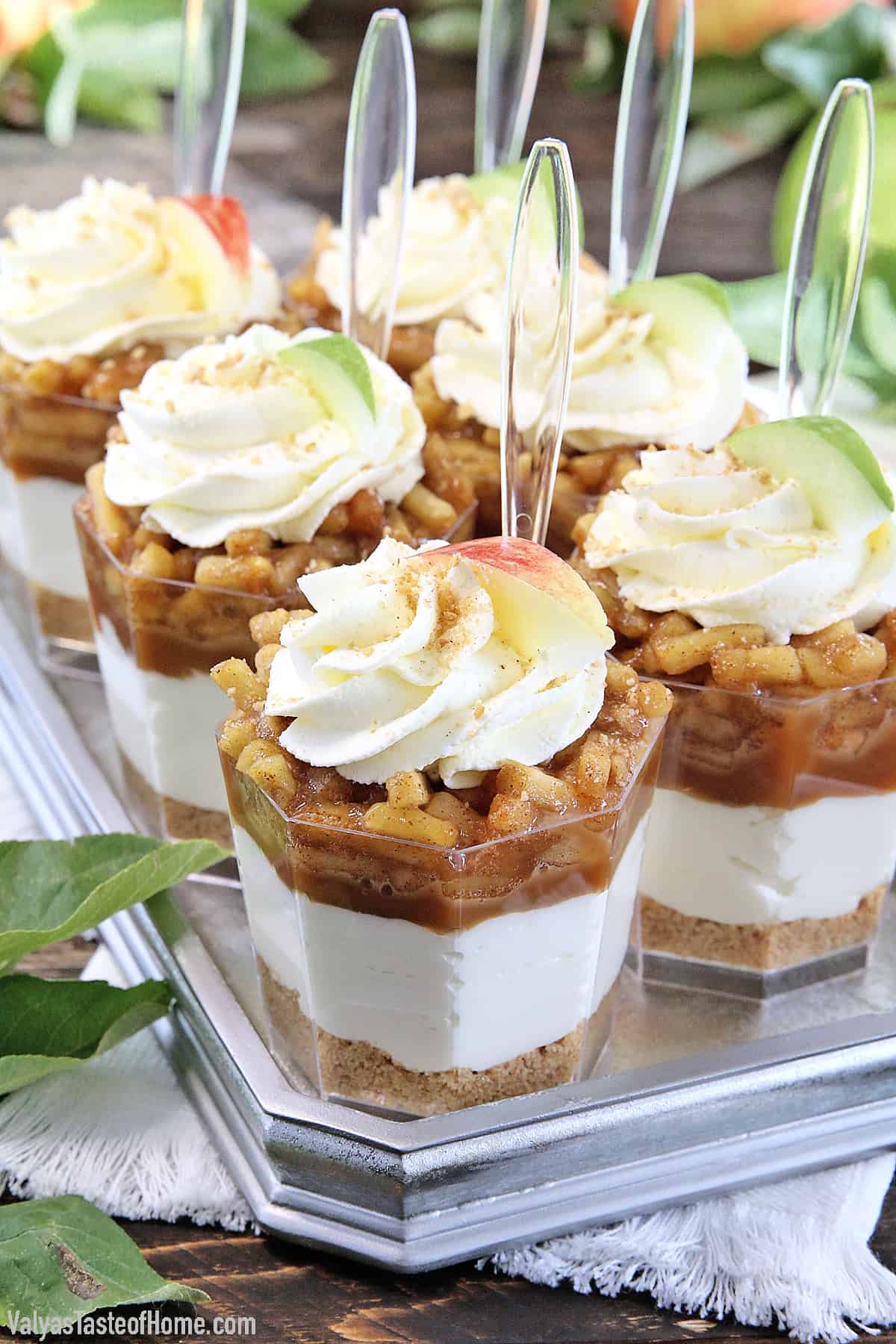 These No-Bake Caramel Apple Pie Cheesecake Parfaits are out of this world delicious! Layers of goodness: crushed buttery graham cracker crust, smooth and creamy cheesecake filling, tasty and rich organic caramel, slathered with fantastic homemade diced apple pie filling, and finally topped with whipped cream.