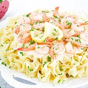 This Shrimp Alfredo Pasta features large shrimp cooked to perfection are covered in a velvety sauce flavored with butter, lemon, and a touch of seasoning.